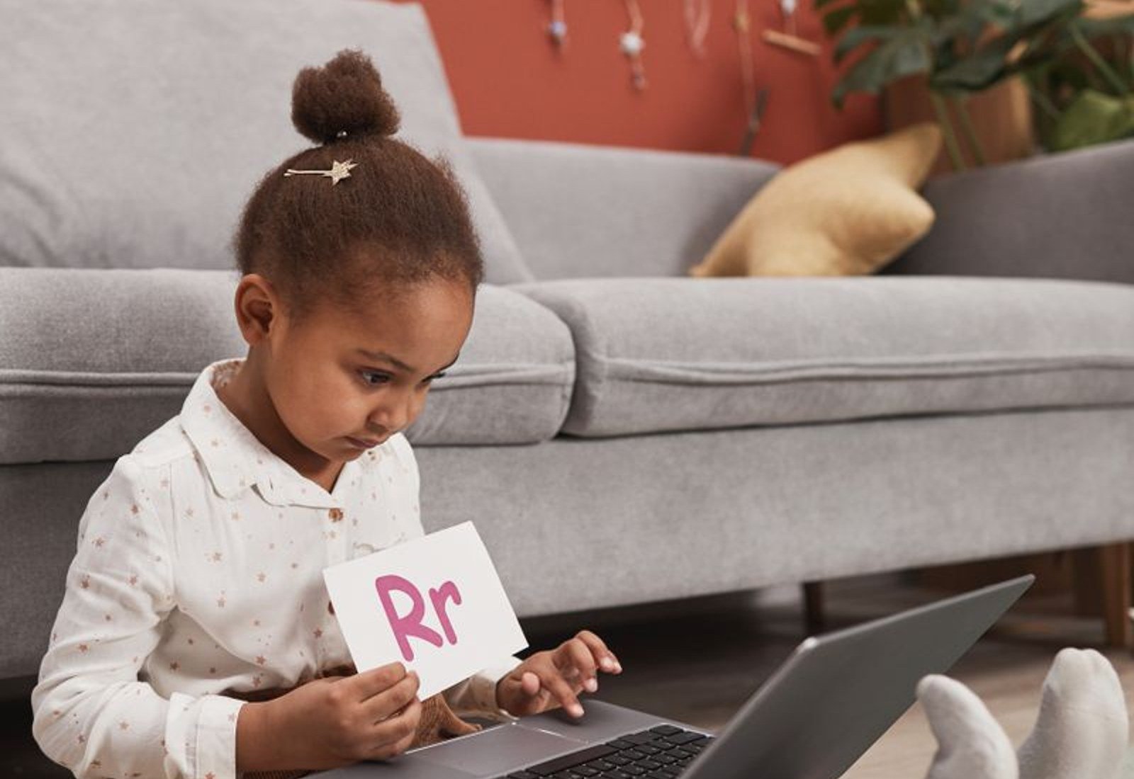 Illustrative photo of a child practising letters and reading
